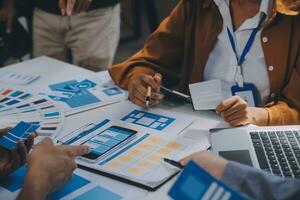 Close up ux developer and ui designer use augmented reality brainstorming about mobile app interface wireframe design on desk at modern office.Creative digital development agency photo