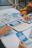 Close up ux developer and ui designer use augmented reality brainstorming about mobile app interface wireframe design on desk at modern office.Creative digital development agency photo