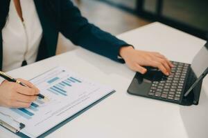 Financial analysts analyze business financial reports on a digital tablet planning investment project during a discussion at a meeting of corporate showing the results of their successful teamwork. photo