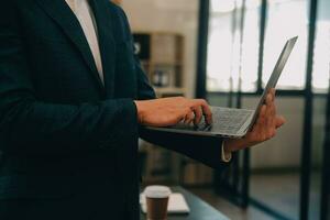 Financial analysts analyze business financial reports on a digital tablet planning investment project during a discussion at a meeting of corporate showing the results of their successful teamwork. photo