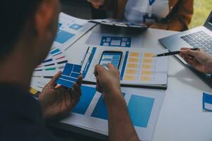 Close up ux developer and ui designer use augmented reality brainstorming about mobile app interface wireframe design on desk at modern office.Creative digital development agency photo