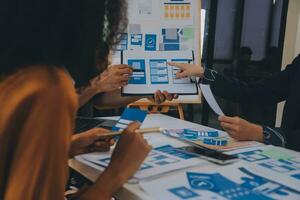 Close up ux developer and ui designer use augmented reality brainstorming about mobile app interface wireframe design on desk at modern office.Creative digital development agency photo