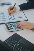 Financial analysts analyze business financial reports on a digital tablet planning investment project during a discussion at a meeting of corporate showing the results of their successful teamwork. photo