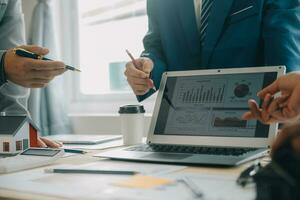 Financial analysts analyze business financial reports on a digital tablet planning investment project during a discussion at a meeting of corporate showing the results of their successful teamwork. photo