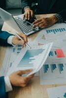 Financial analysts analyze business financial reports on a digital tablet planning investment project during a discussion at a meeting of corporate showing the results of their successful teamwork. photo