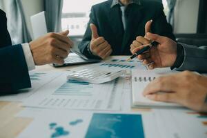 Financial analysts analyze business financial reports on a digital tablet planning investment project during a discussion at a meeting of corporate showing the results of their successful teamwork. photo
