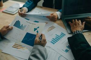 Financial analysts analyze business financial reports on a digital tablet planning investment project during a discussion at a meeting of corporate showing the results of their successful teamwork. photo