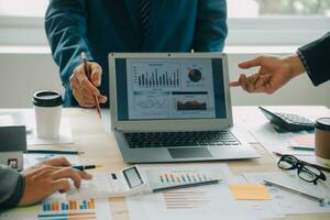 Financial analysts analyze business financial reports on a digital tablet planning investment project during a discussion at a meeting of corporate showing the results of their successful teamwork. photo