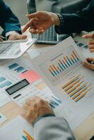 Financial analysts analyze business financial reports on a digital tablet planning investment project during a discussion at a meeting of corporate showing the results of their successful teamwork. photo