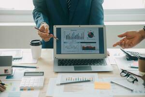 Financial analysts analyze business financial reports on a digital tablet planning investment project during a discussion at a meeting of corporate showing the results of their successful teamwork. photo