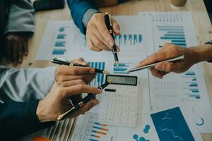 Financial analysts analyze business financial reports on a digital tablet planning investment project during a discussion at a meeting of corporate showing the results of their successful teamwork. photo