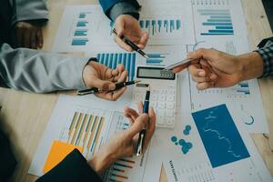 Financial analysts analyze business financial reports on a digital tablet planning investment project during a discussion at a meeting of corporate showing the results of their successful teamwork. photo