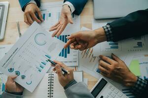 Financial analysts analyze business financial reports on a digital tablet planning investment project during a discussion at a meeting of corporate showing the results of their successful teamwork. photo