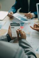 Financial analysts analyze business financial reports on a digital tablet planning investment project during a discussion at a meeting of corporate showing the results of their successful teamwork. photo