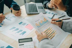 Financial analysts analyze business financial reports on a digital tablet planning investment project during a discussion at a meeting of corporate showing the results of their successful teamwork. photo