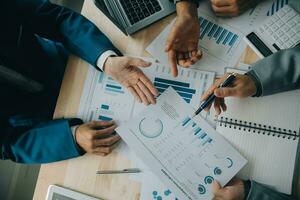 Financial analysts analyze business financial reports on a digital tablet planning investment project during a discussion at a meeting of corporate showing the results of their successful teamwork. photo