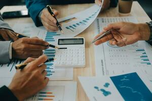 Financial analysts analyze business financial reports on a digital tablet planning investment project during a discussion at a meeting of corporate showing the results of their successful teamwork. photo