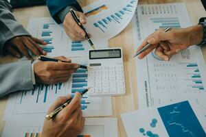 Financial analysts analyze business financial reports on a digital tablet planning investment project during a discussion at a meeting of corporate showing the results of their successful teamwork. photo
