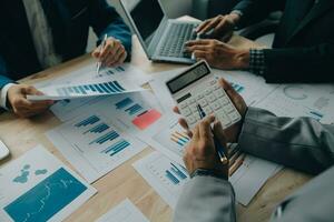 Financial analysts analyze business financial reports on a digital tablet planning investment project during a discussion at a meeting of corporate showing the results of their successful teamwork. photo