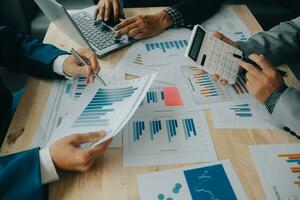 Financial analysts analyze business financial reports on a digital tablet planning investment project during a discussion at a meeting of corporate showing the results of their successful teamwork. photo