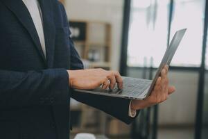 Financial analysts analyze business financial reports on a digital tablet planning investment project during a discussion at a meeting of corporate showing the results of their successful teamwork. photo