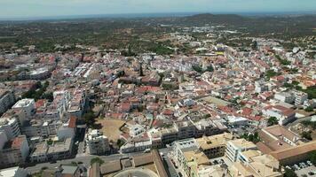 Historic center of Loule, a city in the south of Portugal at sunset. Aerial shot video