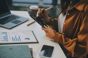 Finance manager meeting discussing company growth project success financial statistics, professional investor working start up project for strategy plan with document, laptop and digital tablet. photo