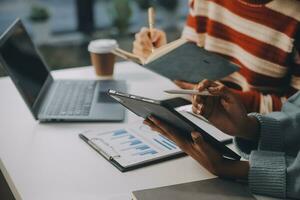Finance manager meeting discussing company growth project success financial statistics, professional investor working start up project for strategy plan with document, laptop and digital tablet. photo