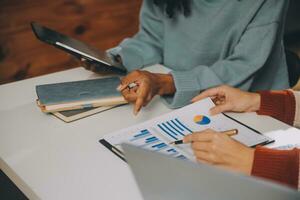 Finance manager meeting discussing company growth project success financial statistics, professional investor working start up project for strategy plan with document, laptop and digital tablet. photo