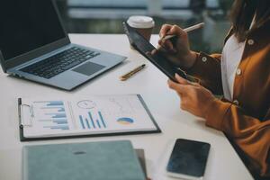 Finance manager meeting discussing company growth project success financial statistics, professional investor working start up project for strategy plan with document, laptop and digital tablet. photo