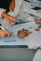 Business team collaboration discussing working analyzing with financial data and marketing growth report graph in team, presentation and brainstorming to strategy planning making profit of company. photo