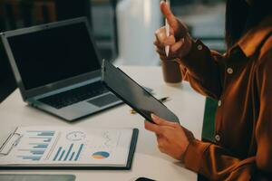 Finance manager meeting discussing company growth project success financial statistics, professional investor working start up project for strategy plan with document, laptop and digital tablet. photo
