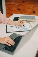 Finance manager meeting discussing company growth project success financial statistics, professional investor working start up project for strategy plan with document, laptop and digital tablet. photo