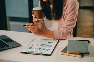 Finance manager meeting discussing company growth project success financial statistics, professional investor working start up project for strategy plan with document, laptop and digital tablet. photo