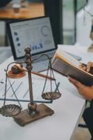 Business and lawyers discussing contract papers with brass scale on desk in office. Law, legal services, advice, justice and law concept picture with film grain effect photo