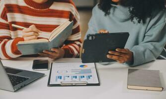 Finance manager meeting discussing company growth project success financial statistics, professional investor working start up project for strategy plan with document, laptop and digital tablet. photo