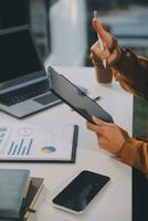 Finance manager meeting discussing company growth project success financial statistics, professional investor working start up project for strategy plan with document, laptop and digital tablet. photo