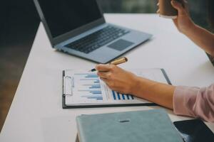Finance manager meeting discussing company growth project success financial statistics, professional investor working start up project for strategy plan with document, laptop and digital tablet. photo