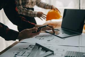 Construction and structure concept of engineer working drawing on blueprint meeting for project working with partner on model building and engineering tools in working site, construction concept. photo
