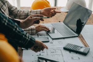 Construction and structure concept of engineer working drawing on blueprint meeting for project working with partner on model building and engineering tools in working site, construction concept. photo