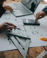 Construction and structure concept of engineer working drawing on blueprint meeting for project working with partner on model building and engineering tools in working site, construction concept. photo