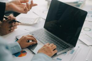 Financial analysts analyze business financial reports on a digital tablet planning investment project during a discussion at a meeting of corporate showing the results of their successful teamwork. photo