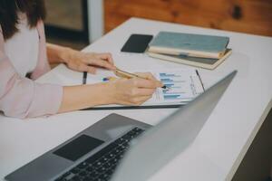 Finance manager meeting discussing company growth project success financial statistics, professional investor working start up project for strategy plan with document, laptop and digital tablet. photo