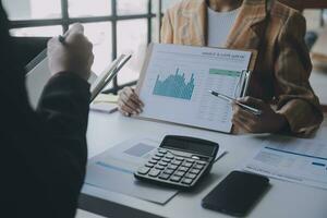 Audit concept,Administrator business man financial inspector and secretary making report calculating balance. Internal Revenue Service checking document. photo