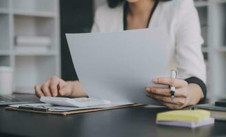 Audit concept,Administrator business man financial inspector and secretary making report calculating balance. Internal Revenue Service checking document. photo