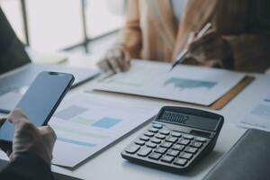 Audit concept,Administrator business man financial inspector and secretary making report calculating balance. Internal Revenue Service checking document. photo