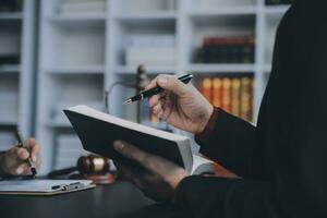 Business and lawyers discussing contract papers with brass scale on desk in office. Law, legal services, advice, justice and law concept picture with film grain effect photo