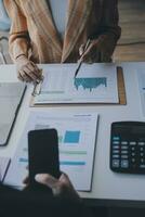 Audit concept,Administrator business man financial inspector and secretary making report calculating balance. Internal Revenue Service checking document. photo