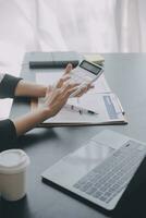 Audit concept,Administrator business man financial inspector and secretary making report calculating balance. Internal Revenue Service checking document. photo