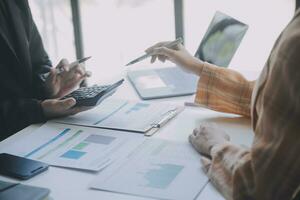 Audit concept,Administrator business man financial inspector and secretary making report calculating balance. Internal Revenue Service checking document. photo
